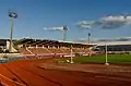 Blick auf die Haupttribüne und rechts im Hintergrund die Trainingshalle (Juni 2012)