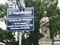 Straßenschild 7., Augustinplatz. Darunter Zusatztafel mit den biografischen Grunddaten des Namensgebers und der Namensgeberin, nach denen der Platz im Mai 2009 benannt wurde.