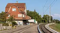 Bahnhofsgebäude mit Mansardendach und gekuppelten Fenstern