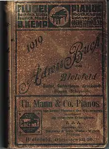 Werbung von Pianohaus B. Kemp und Pianofabrik Th. Mann & Co. auf dem Buchdeckel des Adressbuchs von Bielefeld von 1919.