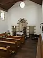 Inneres der Blandine-Merten-Kapelle mit Blick zur Apsis mit dem Reliquienschrein der Seligen hinter dem Altar