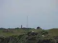 Gebiet des Cape Foulwind Lighthouse mit neuem Turm, Antennenmast und Hügel des alten Leuchtturmes
