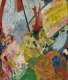 Ausschnitt des Gemäldes „Der Einzug Christi in Brüssel“. Zu sehen ist eine dämonisch wirkende Figur in gelb mit schwarzen Haaren und rotem Spitzhut. Um sie herum befinden sich zwei weitere Figuren: eine Figur in rosa mit rosa Blumenhut, eine Figur in grün mit Pierrot-Maske und rosa Hut und eine undefinierbare Figur oder Form, die aus einer großen orangenen Kugel und einer kleinen grünen Kugel, eventuell auch ein Kopf mit aufgerissenem Mund, besteht.