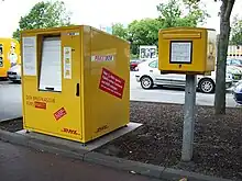 Paketbox links und Stadtbriefkasten rechts.