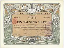 Aktie der Deutsch-Ueberseeischen Elektricitäts-Gesellschaft (Compañía Alemana Transatlántica de Electricidad) über 1.000 Mark, ausgestellt in Berlin im Juli 1906. Mit Faksimileunterschrift Arthur von Gwinner (Vorstand Deutsche Bank) als Aufsichtsratsvorsitzender. Die graphische Gestaltung der Aktie stammt von dem Jugendstil-Künstler Otto Eckmann. Zweck der von der AEG gegründeten Gesellschaft war die Errichtung von Elektrizitätswerken vor allem in Südamerika (Buenos Aires, Santiago de Chile, Valparaiso, Montevideo). Die mit Abstand wichtigste Aktivität wurde später die Stromversorgung der argentinischen Hauptstadt Buenos Aires.