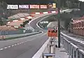 1997, als öffentliche Straße, die in der Senke links abbiegt (für Lkw Pflicht). In Rennrichtung bergauf bestand die Möglichkeit, die Steige (Raidillon) zu befahren