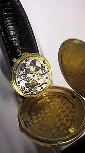 Ebel-Sprungdeckelarmbanduhr (in echt goldener Zwanzig-Dollar-Münze von 1897 der USA)