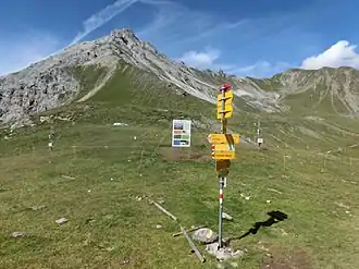 Wegweiser auf der Latschüelfurgga. Im Hintergrund Chüpfenflue (links) und Strela (rechts).