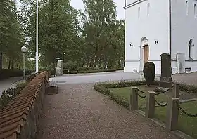 Fosiestein (links) vor der Kirche