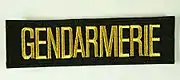 Schriftzug auf den Uniformen der Gendarmerie