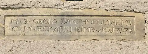Steintafel an der Kirche mit Jahreszahl 1717. Die Namen sind vermutlich die Stifter der Kirche oder des Kirchturms