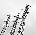 Links ein Abspannmast der Leitung, bei dem die jeweils einseitige Isolation auf 220 kV und 380 kV (Langstabisolatoren) erkennbar ist.