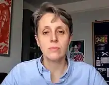 Eine Webcam-Aufnahme einer Frau mit kurzen, grauen Haaren.