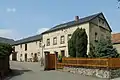 Wohnhaus mit Stallanbau und Scheune im Winkel, Hofmauer und Hofeinfahrt