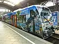 Regio-Shuttle mit Wer­bung für den Urlaubs­markt im Bf Lei­pzig Hbf