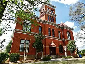 Madison County Courthouse (2014). Das Courthouse entstand 1901 im Stile der Neuromanik. Auf den ausführenden Architekten J. W. Golucke und seine Firma gehen mehr als ein Dutzend Gerichts- und Verwaltungsgebäude in Georgia und Alabama zurück. Das Madison County Courthouse wurde im September 1980 als zweites Objekt im County in das NRHP eingetragen.