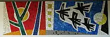 Mosaik, Vogelzug, von Hans Weidmann (1918–1997), Wasgenringschule Basel. Im Auftrag des Kunstkredits Basel-Stadt. Gestaltung von sieben Pavillon-Trennwänden (1953–1955). Die Wandbilder von Otto Abt, Ernst Stocker und Hans Weidmann wurden 1958 resp. 1980/81 durch Mosaike ersetzt, das stark beschädigte Werk von Theo Eble 1986 restauriert.
