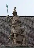 48. Militärwesen – Soldat, Lanze, Putto mit Trommel.