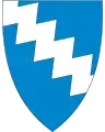 Abbildung eines Wappen mit blauem Hintergrund, darauf eine weiße gezackte Fläche
