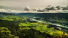 Foto einer Tallandschaft mit einem Fluss im Zentrum des Tals