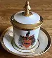 Marken: TPM u. preußischer Adler, (ca. 1848) u. auf dem Kopf stehende Taube (1848–62), Bouillon Tasse m. Wappenmalerei u. Vergoldungen.