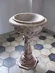 Das Taufbecken befindet sich in einem Gewölbe rechts vom Altar der Kirche.