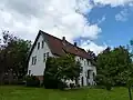 Typisch: weiße Fassade, grüne Fenster, rotes Dach