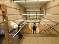 Abgang von der Verteilerebene zur Bahnsteigebene, mit Eröffnungsdatum an der Decke