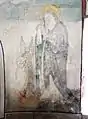 Zwischen den beiden Fenstern der Apsis geben die hl. Ottilie (mit Buch und Augen) und ein Engel einer Seele im Fegefeuer ihren Zuspruch.