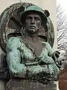 Symbolfigur „Handel“ mit Merkurstab und Eisenbahn-symbolen (Rad und Schiene)