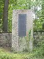 Früher Gedenkstein mit Metalltafel, Inschrift: „Gewalt stahl lieblos Leben und Recht. […]“