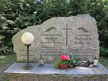 Dieser Stein erinnert an die ehemaligen deutschen Bewohner, die auf dem damaligen evangelischen Friedhof beerdigt wurden.
