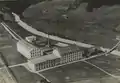 Historisches Luftbild der Weberei Legler in Diesbach (Gemeinde Glarus Süd) von Walter Mittelholzer zwischen 1918 und 1937